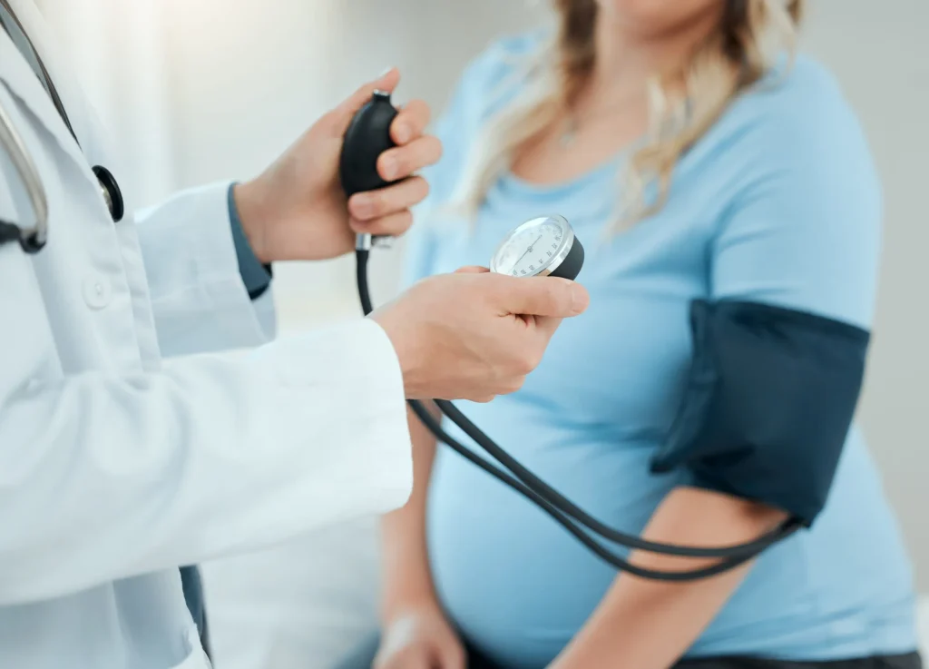 Blood pressure checkup with pregnant patient