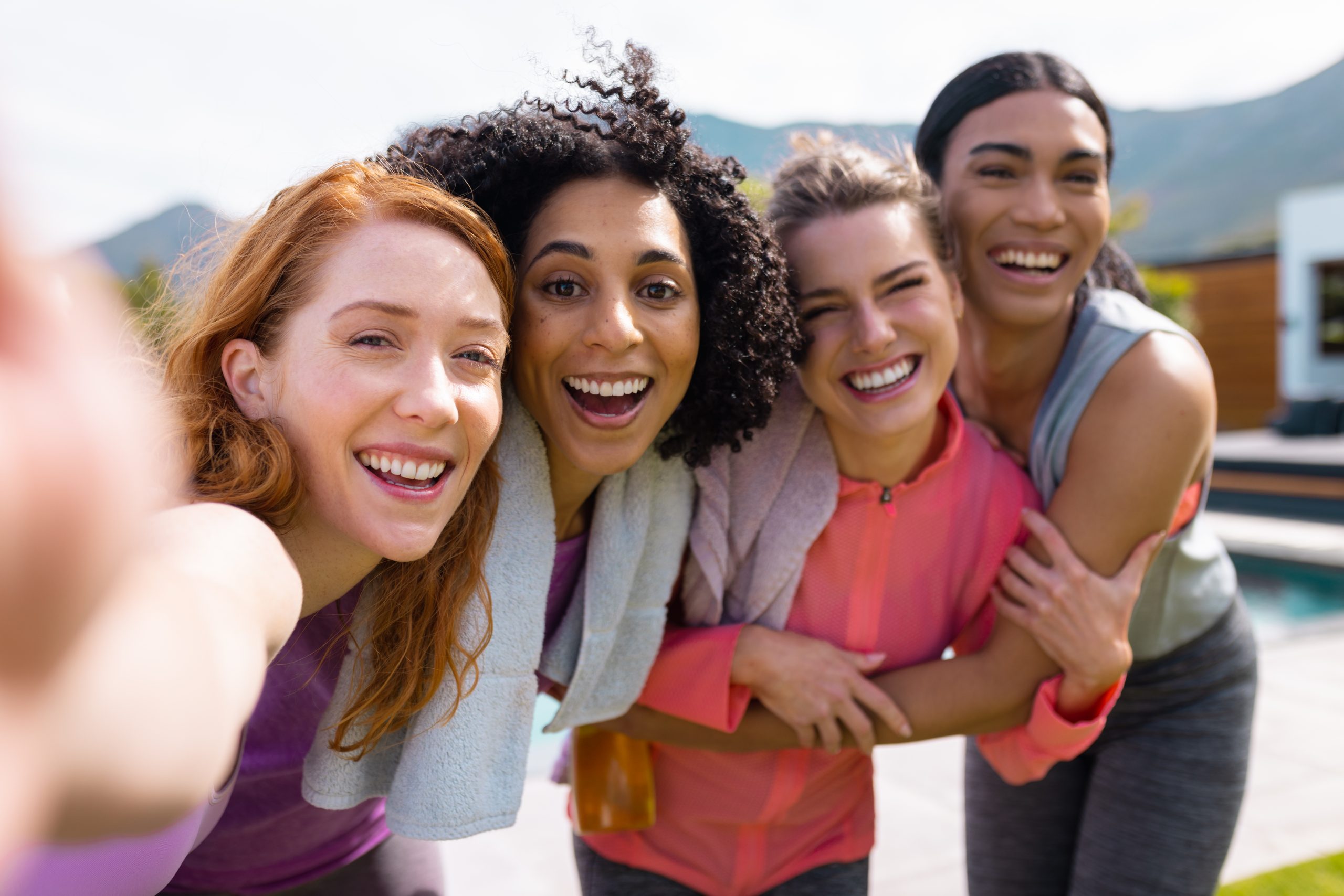 young women all smiles taking a selfie
